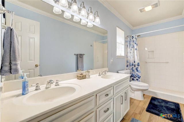 bathroom with a sink, a tile shower, toilet, and visible vents