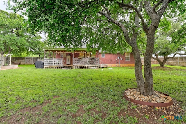 view of yard featuring a fenced backyard and a wooden deck