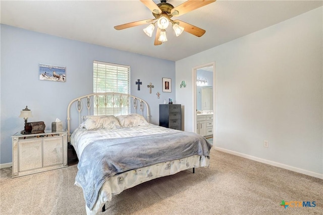 bedroom with baseboards, carpet flooring, a ceiling fan, and ensuite bath