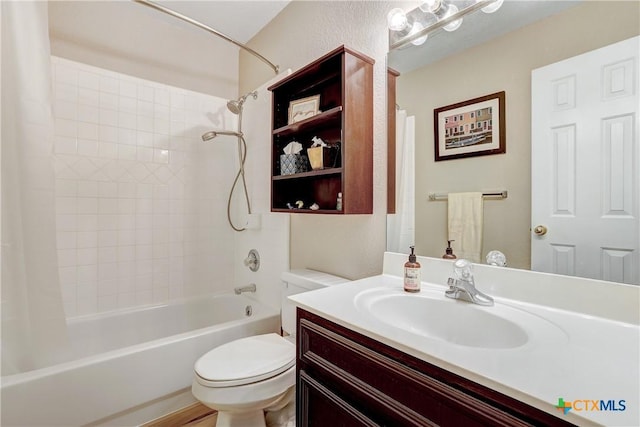 bathroom with vanity, shower / bath combo with shower curtain, and toilet