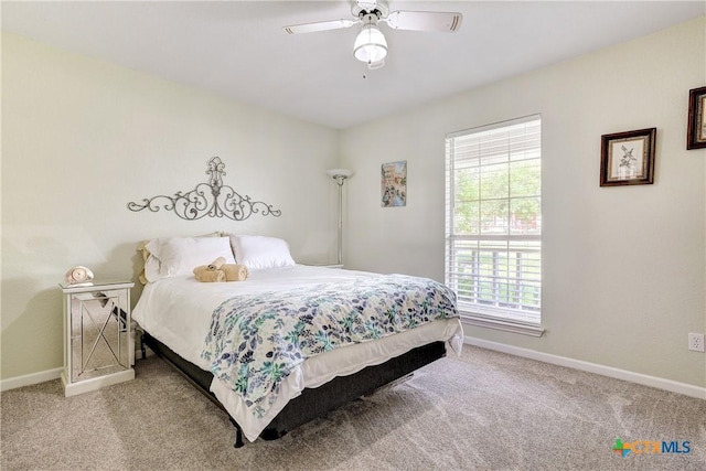 bedroom with carpet flooring, baseboards, and ceiling fan
