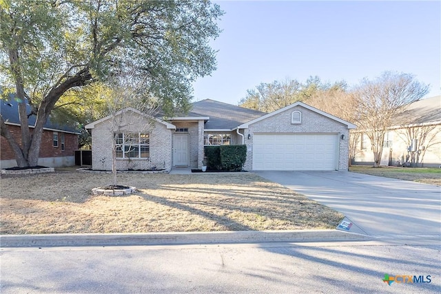 ranch-style house with brick siding, concrete driveway, and an attached garage