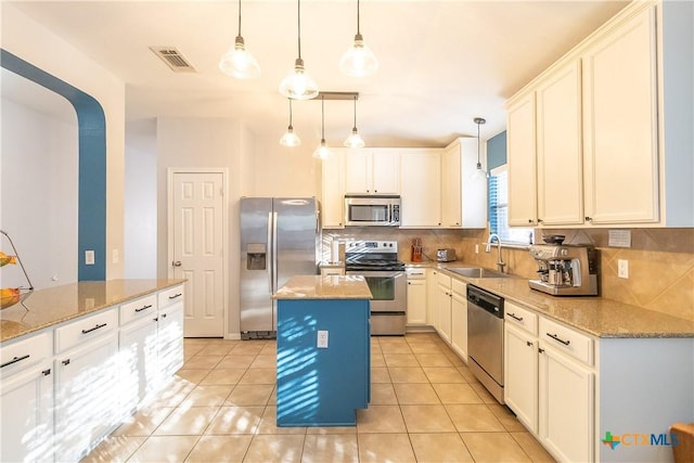 kitchen featuring visible vents, appliances with stainless steel finishes, decorative backsplash, and a sink