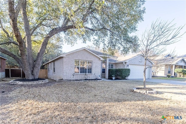 ranch-style house with concrete driveway, an attached garage, fence, and brick siding