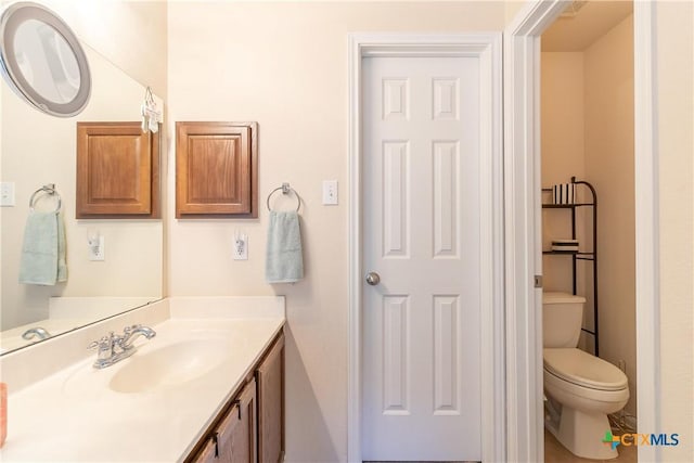 bathroom featuring toilet and vanity