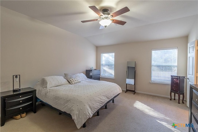 bedroom with light carpet, baseboards, lofted ceiling, and a ceiling fan