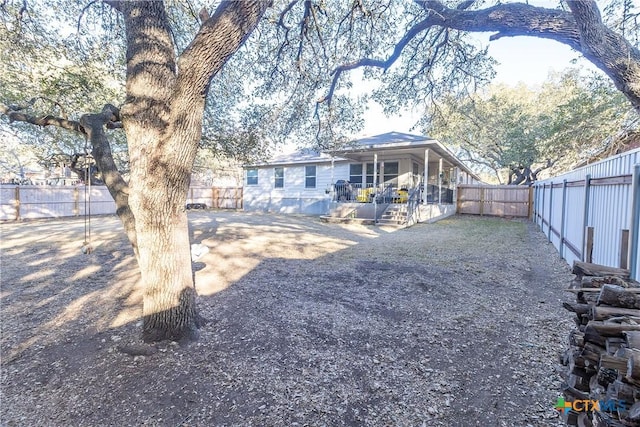 exterior space with a fenced backyard