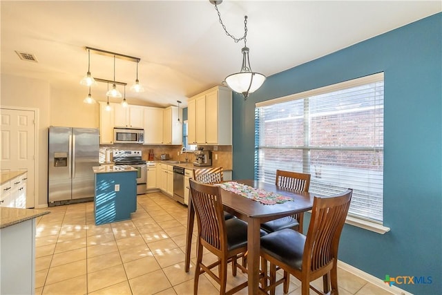 dining room with light tile patterned floors, baseboards, and visible vents