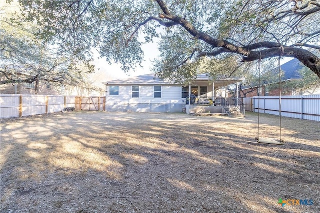 back of property featuring a fenced backyard