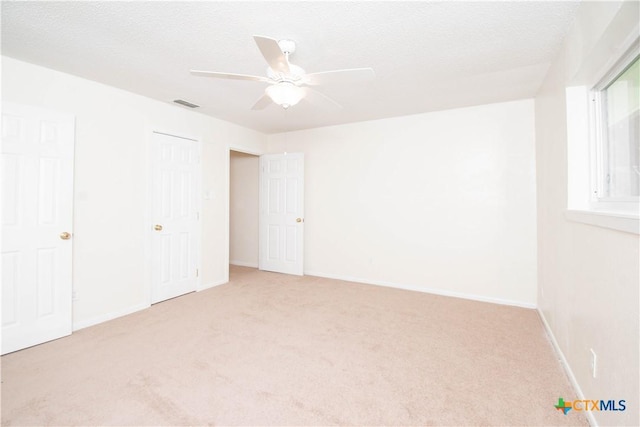 unfurnished bedroom with visible vents, baseboards, and carpet flooring