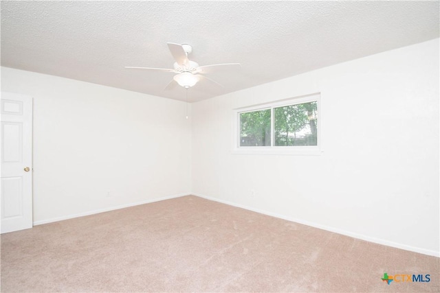 empty room with baseboards, carpet flooring, and ceiling fan