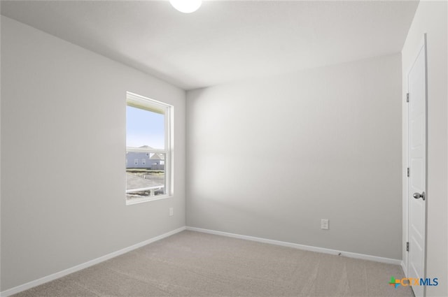 unfurnished room featuring light colored carpet