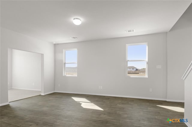 spare room with dark wood-type flooring