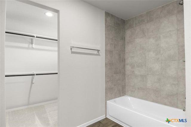 bathroom featuring hardwood / wood-style flooring and tiled shower / bath