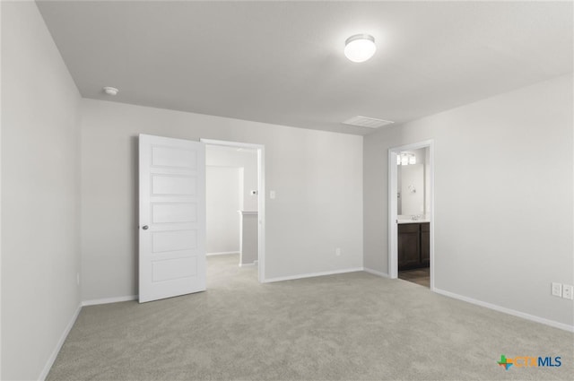 unfurnished bedroom featuring carpet flooring and connected bathroom