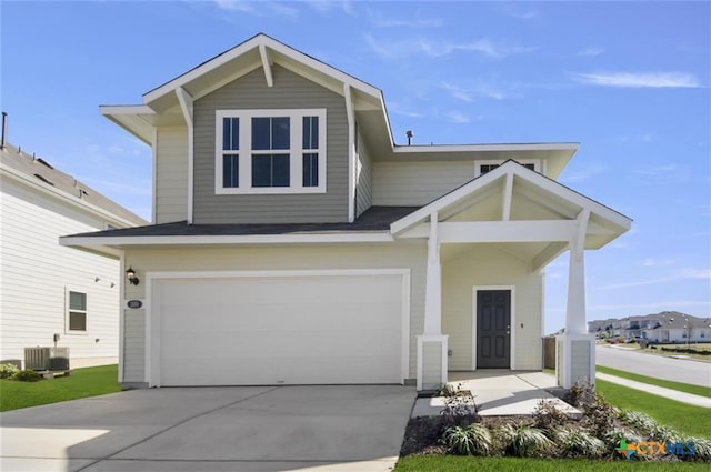 front facade featuring a garage and central AC unit