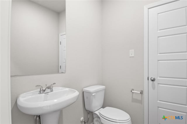 bathroom featuring sink and toilet