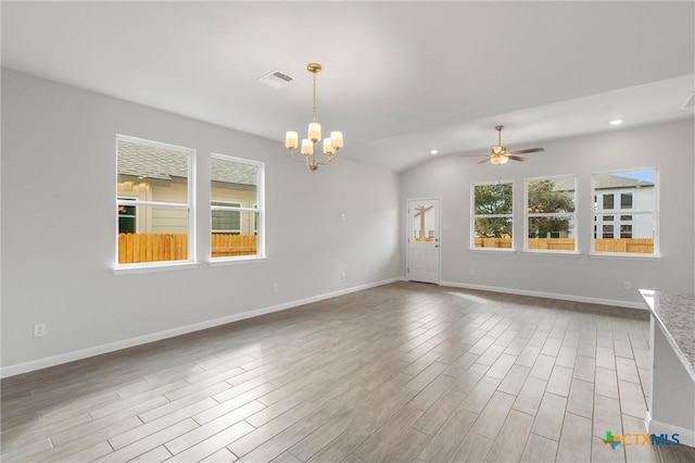 unfurnished room with ceiling fan with notable chandelier