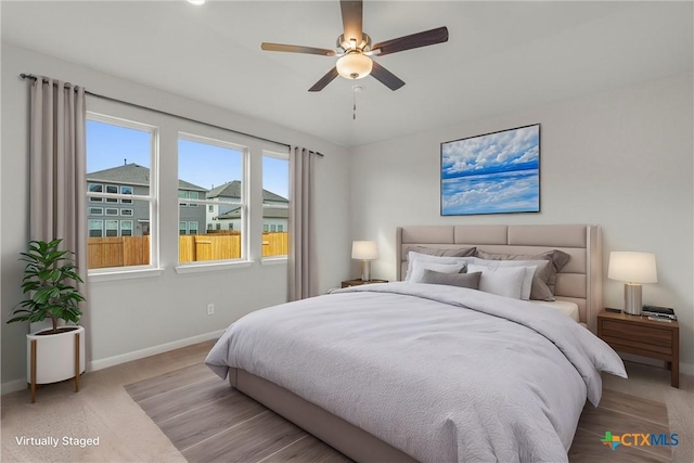 bedroom featuring ceiling fan and light carpet