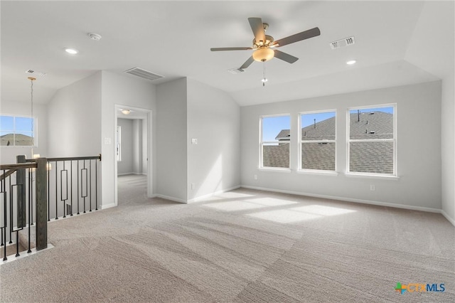 unfurnished room with vaulted ceiling, ceiling fan, and light colored carpet