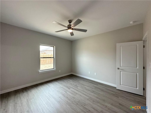 empty room featuring wood-type flooring and ceiling fan