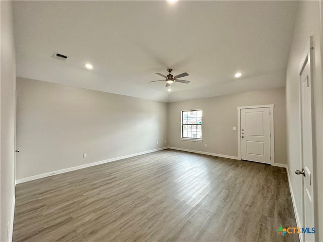 spare room with hardwood / wood-style flooring and ceiling fan