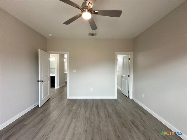 unfurnished bedroom with ceiling fan and dark hardwood / wood-style floors