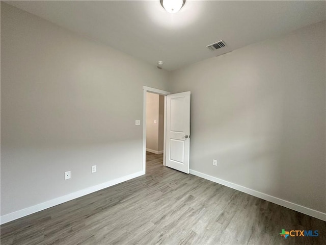 spare room featuring light hardwood / wood-style flooring