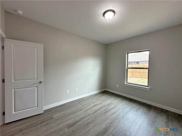 spare room with wood-type flooring