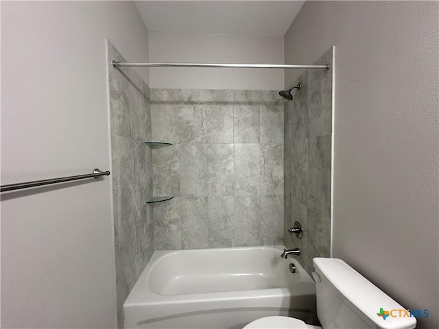 bathroom featuring tiled shower / bath and toilet