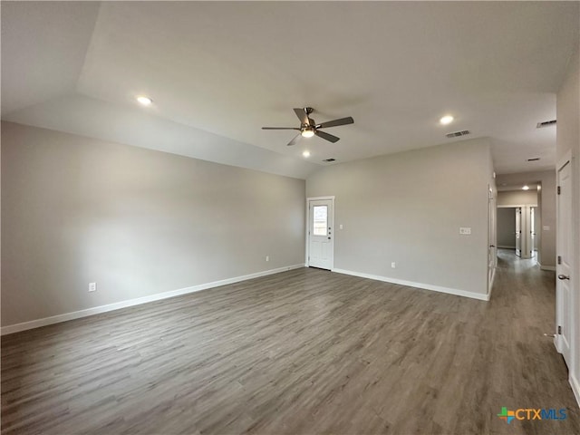 unfurnished room featuring dark wood-type flooring, ceiling fan, and vaulted ceiling