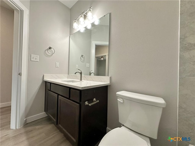 bathroom with vanity, hardwood / wood-style floors, and toilet