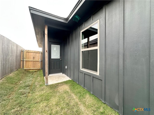 view of side of home featuring a lawn