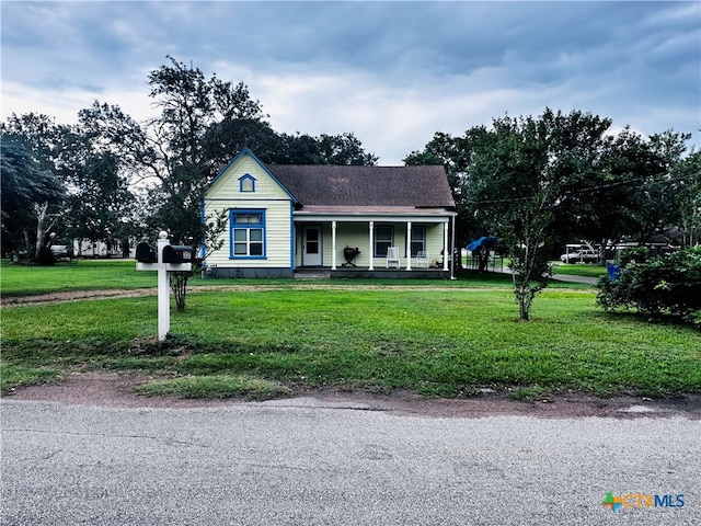 view of front of property with a porch and a front lawn