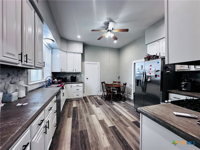 kitchen featuring stainless steel fridge, backsplash, white cabinetry, hardwood / wood-style flooring, and ceiling fan