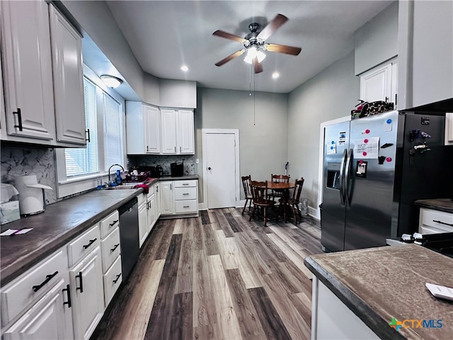 kitchen featuring stainless steel appliances, decorative backsplash, dark hardwood / wood-style floors, ceiling fan, and white cabinetry