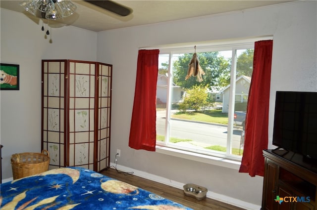 bedroom featuring ornamental molding, dark hardwood / wood-style flooring, and ceiling fan