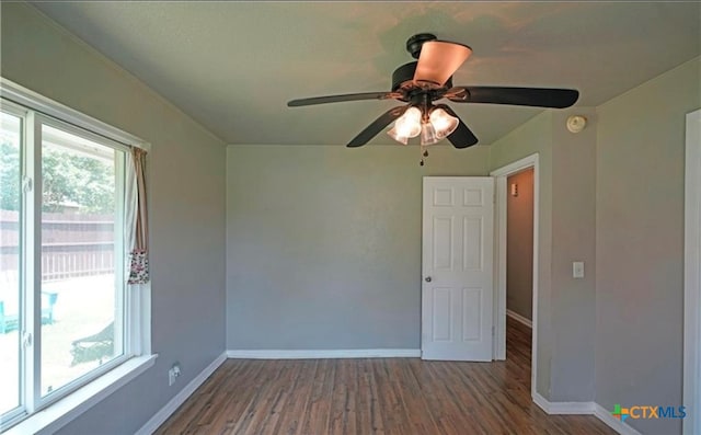 unfurnished room with hardwood / wood-style floors and ceiling fan