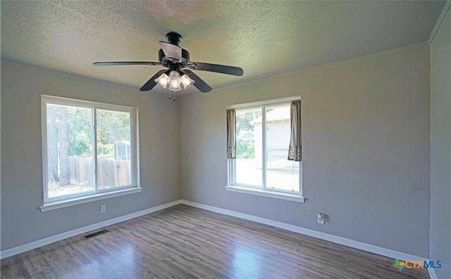 spare room featuring hardwood / wood-style flooring, ceiling fan, and a textured ceiling