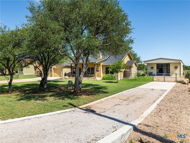 2091 County Road 100, Burnet, TX 78611 - view of front of home with gravel driveway and a gate