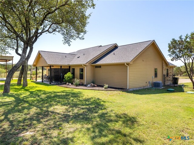 2091 County Road 100, Burnet, TX 78611 - rear view of property with a yard, central air condition unit, roof with shingles, and a patio