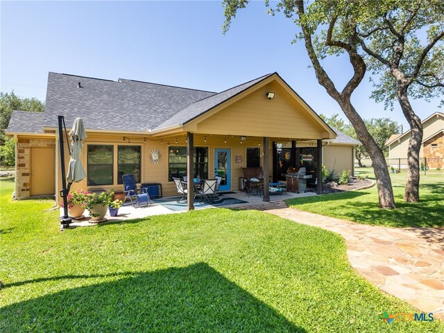 2091 County Road 100, Burnet, TX 78611 - rear view of property featuring a patio and roof with shingles