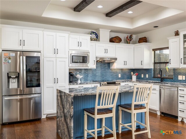 2091 County Road 100, Burnet, TX 78611 - kitchen featuring appliances with stainless steel finishes, extractor fan, a sink, decorative backsplash, and dark wood-style flooring