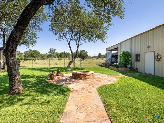 2091 County Road 100, Burnet, TX 78611 - view of yard featuring an outdoor fire pit and a patio