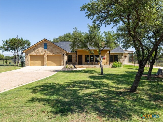 2091 County Road 100, Burnet, TX 78611 - ranch-style home featuring stone siding, an attached garage, concrete driveway, and a porch