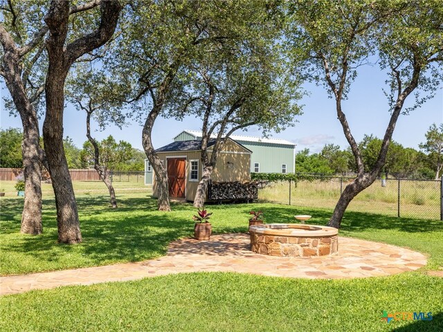 2091 County Road 100, Burnet, TX 78611 - view of yard with a fire pit and a patio area