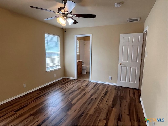 240 Ibis Falls Dr, New Braunfels, TX 78130 - unfurnished bedroom featuring baseboards, dark wood-type flooring, ensuite bathroom, and ceiling fan