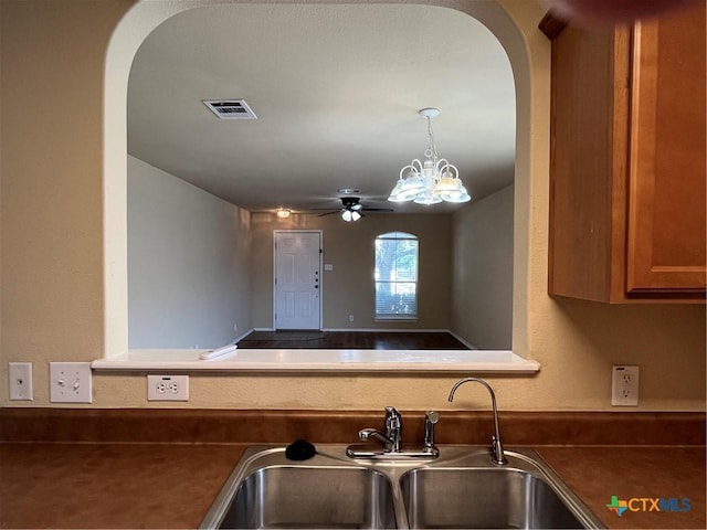 240 Ibis Falls Dr, New Braunfels, TX 78130 - kitchen featuring a sink, arched walkways, ceiling fan, and dark countertops