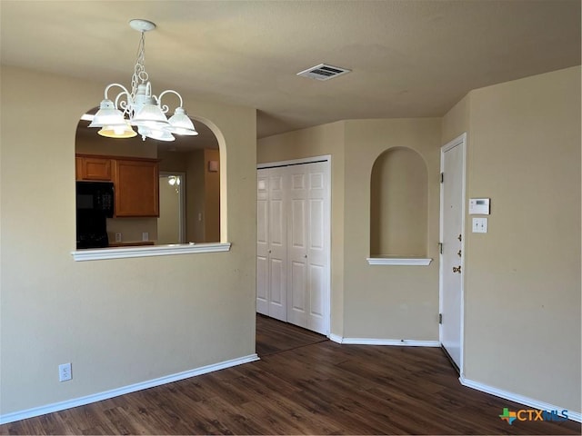 240 Ibis Falls Dr, New Braunfels, TX 78130 - unfurnished dining area featuring baseboards, dark wood-type flooring, arched walkways, and a chandelier