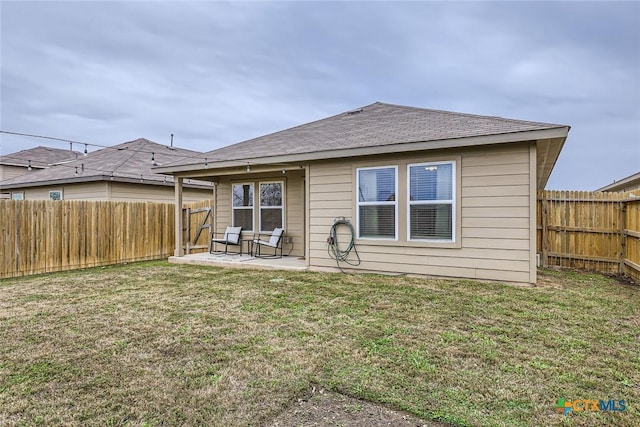 back of property featuring a patio and a lawn